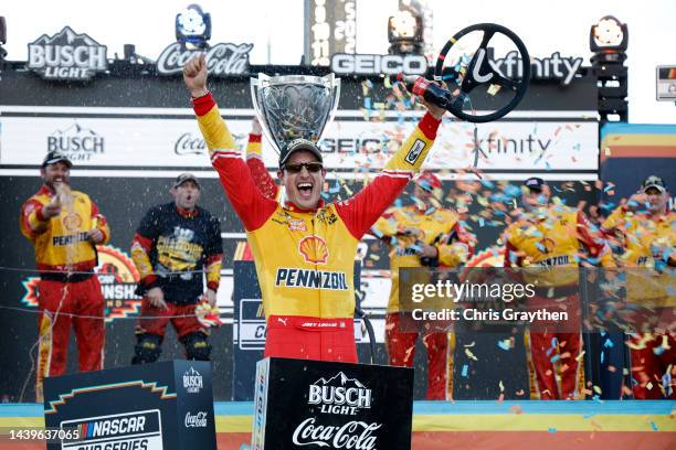 Joey Logano, driver of the Shell Pennzoil Ford, celebrates in victory lane after winning the 2022 NASCAR Cup Series Championship at Phoenix Raceway...