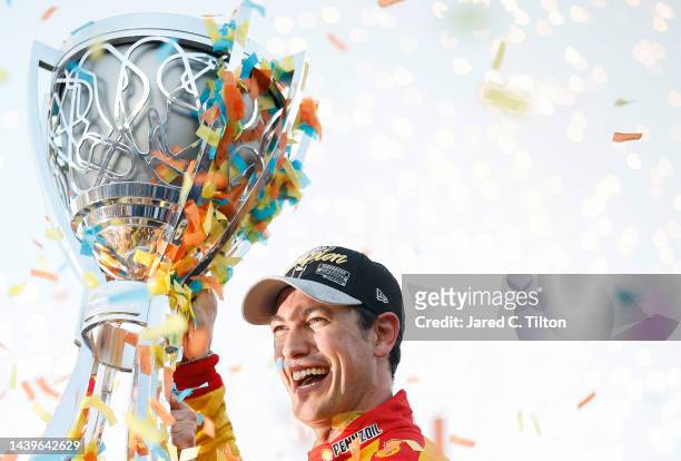 Joey Logano, driver of the Shell Pennzoil Ford, lifts the Bill France NASCAR Cup Series Championship trophy in victory lane after winning the 2022...