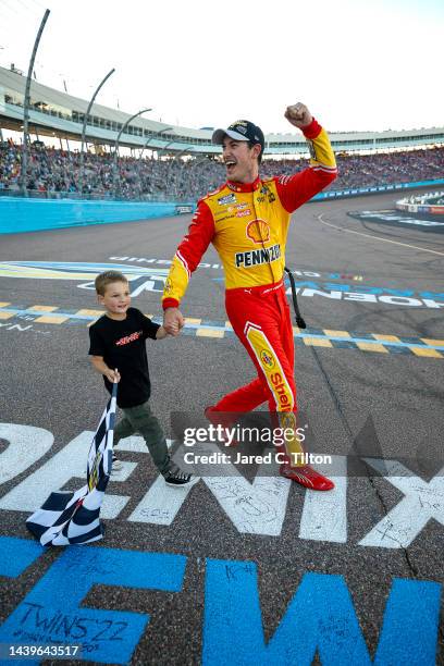 Joey Logano, driver of the Shell Pennzoil Ford, celebrates with his son, Hudson after winning the 2022 NASCAR Cup Series Championship at Phoenix...