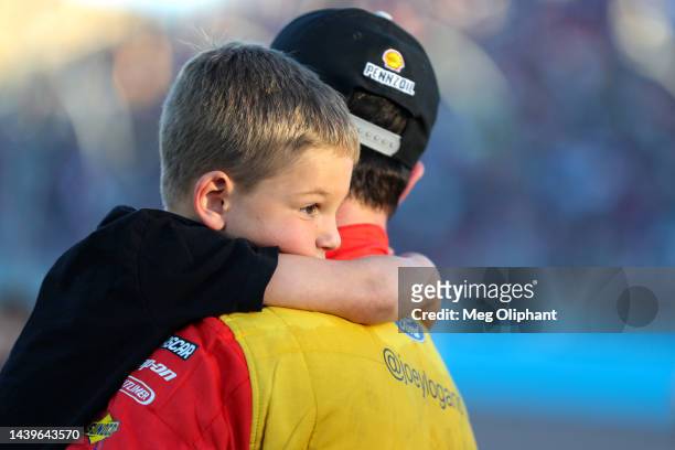 Joey Logano, driver of the Shell Pennzoil Ford, celebrates with his son, Hudson after winning the 2022 NASCAR Cup Series Championship at Phoenix...