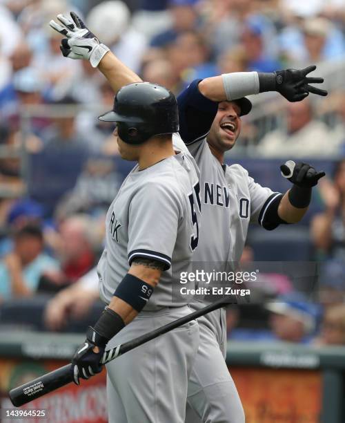 Nick Swisher of the New York Yankees celebrates his home run with Russell Martin during a game against the Kansas City Royals at Kauffman Stadium May...