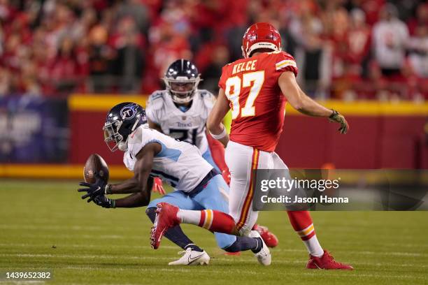 Roger McCreary of the Tennessee Titans intercepts a pass intended for Travis Kelce of the Kansas City Chiefs in the second half at Arrowhead Stadium...