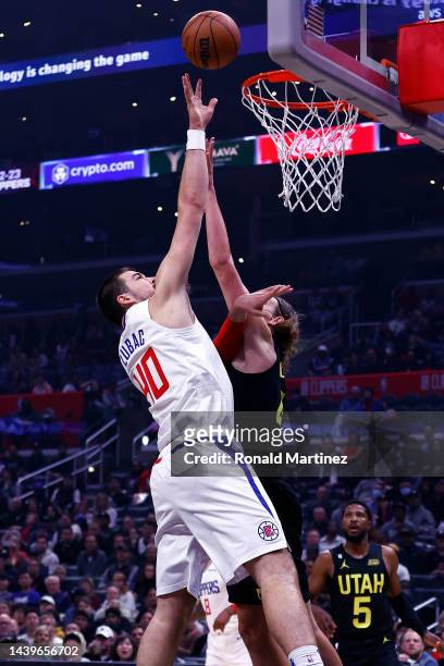 Ivica Zubac of the LA Clippers takes a shot against Kelly Olynyk of the Utah Jazz in the first half at Crypto.com Arena on November 06, 2022 in Los...