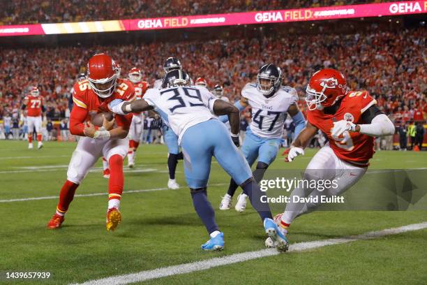 Patrick Mahomes of the Kansas City Chiefs gets past Terrance Mitchell and Andrew Adams of the Tennessee Titans to run in for a touchdown at Arrowhead...