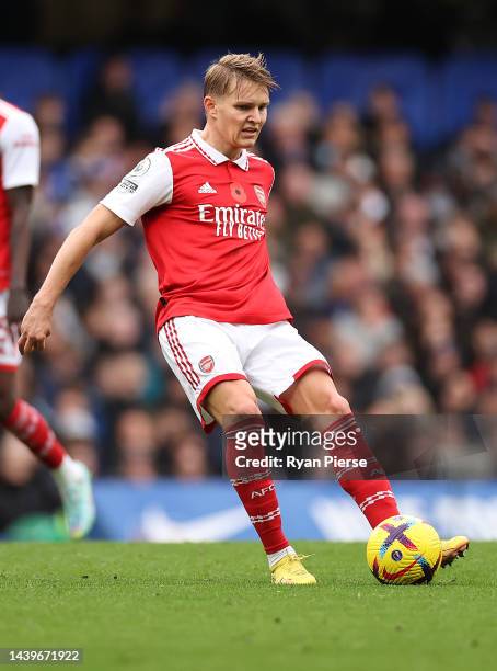 Martin Odegaard of Arsenal passes the ball during the Premier League match between Chelsea FC and Arsenal FC at Stamford Bridge on November 06, 2022...
