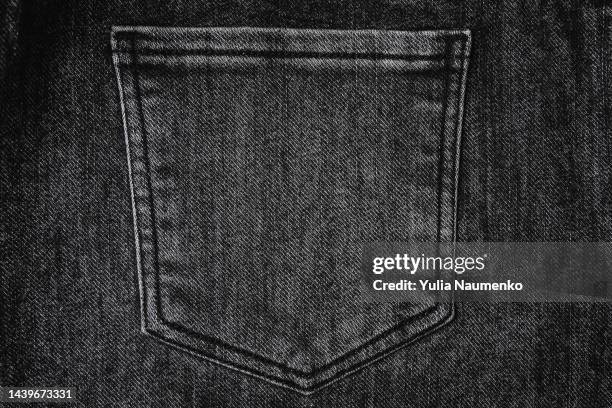 black denim. jeans background full frame. - black trousers stockfoto's en -beelden