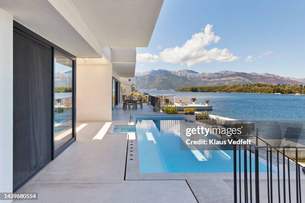 swimming pool with blue water on sunny day - villa stock-fotos und bilder