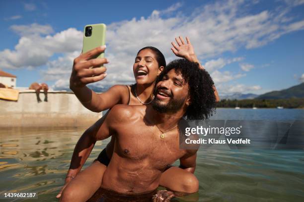 woman taking selfie with friend during vacation - travel stock-fotos und bilder