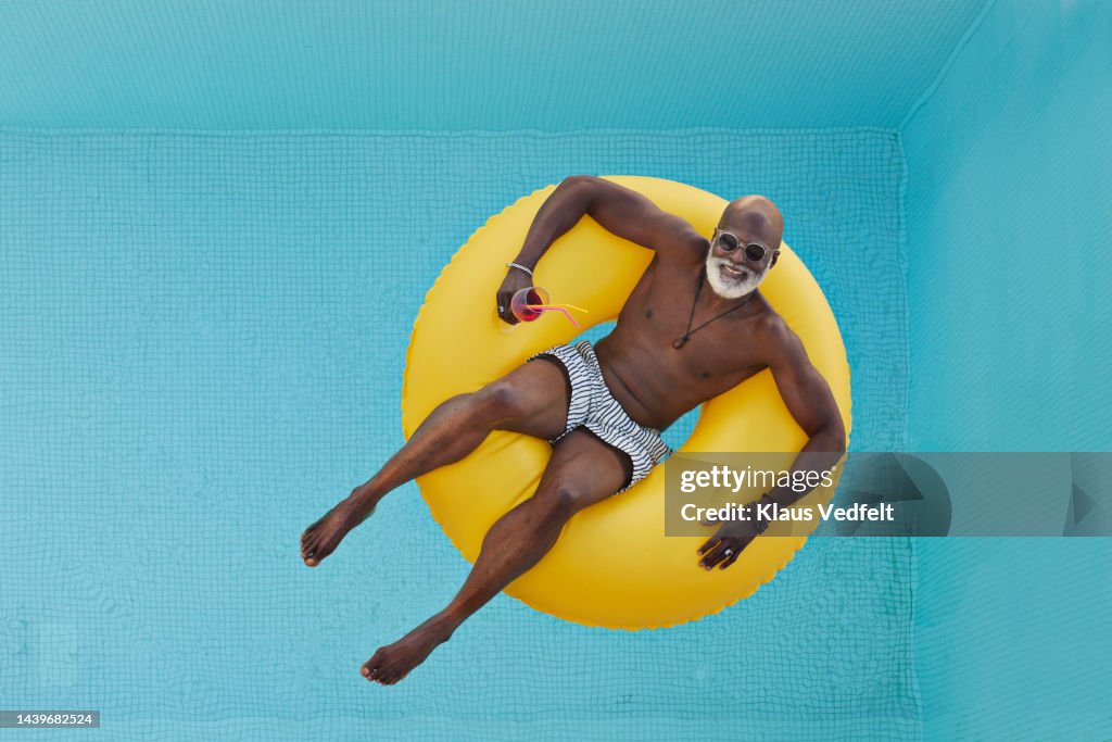 Man relaxing in yellow inflatable ring