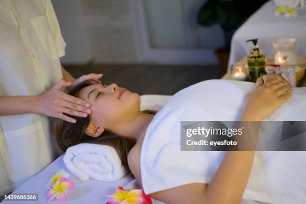customer and employee are at spa and resort. - happy thai massage stock pictures, royalty-free photos & images