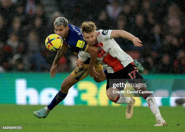 Bruno Guimaraes of United is challenged by Stuart Armstrong of Southampton during the Premier League match between Southampton FC and Newcastle...