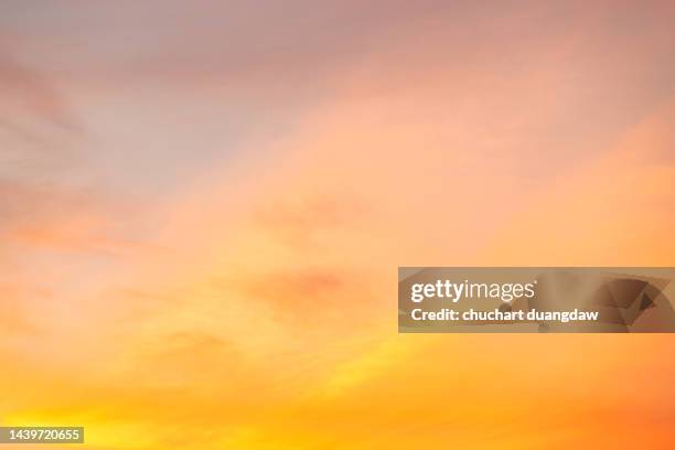 beautiful sky of orange and pink clouds in the sky at sunset springtime - orange sky stock-fotos und bilder