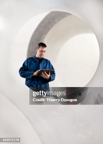 Aerospace technician using tablet Aerospace technician using tablet