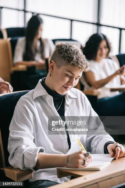 student taking notes from university lecture - estonia technology stock pictures, royalty-free photos & images