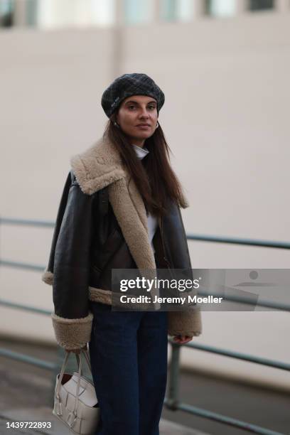 Anna Winter is seen wearing grey/beige checked Miu Miu beret hat, white turtleneck from Weekday, brown doubleface jacket from Zara, dark blue Closed...