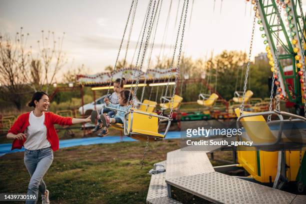 little girls on chain swing ride - season 4 bildbanksfoton och bilder