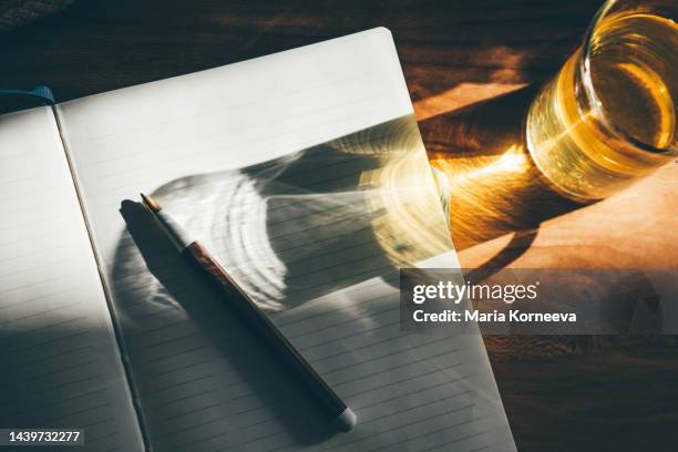 notebook, pen, cup of tea on the table. - story telling in the workplace stock pictures, royalty-free photos & images