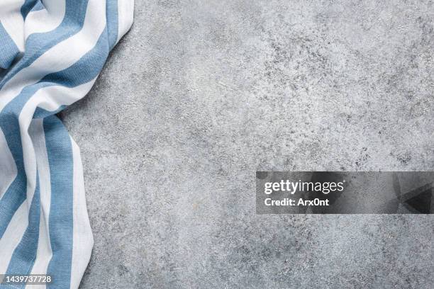 blue striped kitchen towel on grey concrete background - straccio da cucina foto e immagini stock