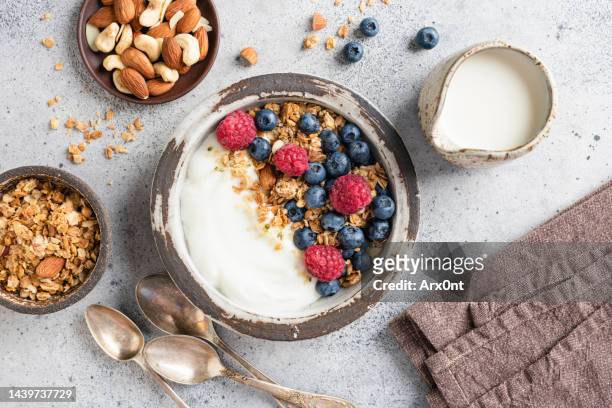 yogurt bowl with granola and berries - breakfast bowl stock pictures, royalty-free photos & images