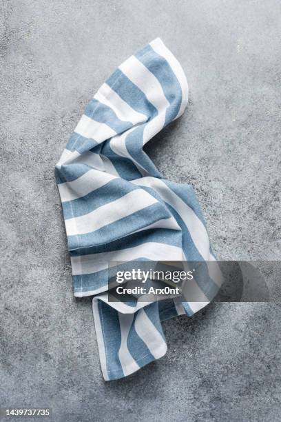 blue triped kitchen towel on grey background - servilleta fotografías e imágenes de stock