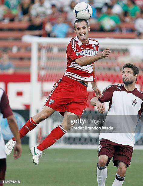 Andrew Jacobson of the FC Dallas heads the ball as Drew Moor of the Colorado Rapids looks on during the second half of a soccer game at FC Dallas...