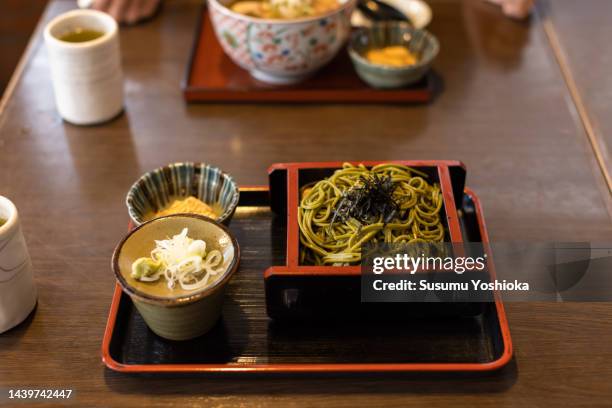 a woman eating japanese food at a japanese restaurant. - kamakura stock photos et images de collection