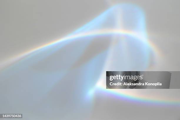 surreal rainbow laser light refraction texture overlay effect on white wall - lumières photos et images de collection