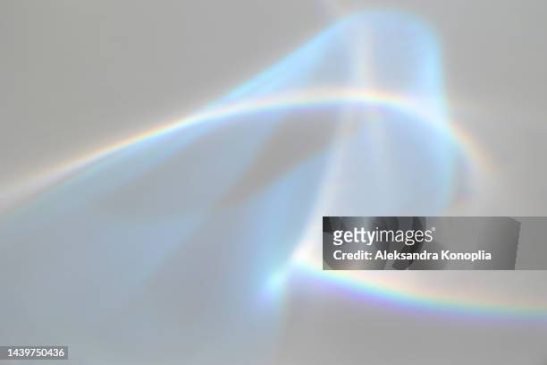 surreal rainbow laser light refraction texture overlay effect on white wall - glass material stock pictures, royalty-free photos & images