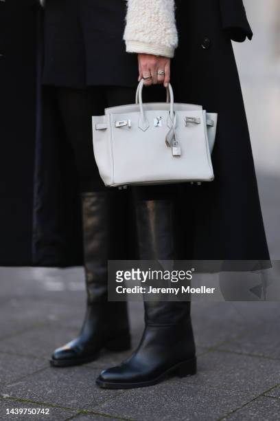 Patricia Wirschke is seen wearing white/creme fluffy cardigan from Massimo Dutti, black shorts, black tights, white/light grey leather Hermès Birkin...