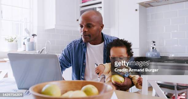 work from home, laptop and father with baby working, typing or doing online research for child care, time management and finance planning. remote work, child and black family dad in kitchen on his pc - family time homework time stock pictures, royalty-free photos & images