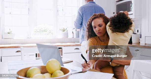 work from home parents on laptop and baby for budget, finance and planning mortgage or internet tax in a kitchen. mother with child remote working on time management, writing notes and multitasking - busy toddlers stock pictures, royalty-free photos & images