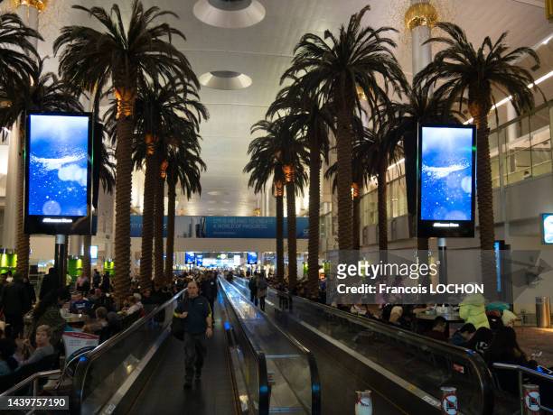 Voyageurs en salle d'attente et sur des tapis roulant à l'aéroport de Dubaï le 12 décembre 2016 à Dubaï city