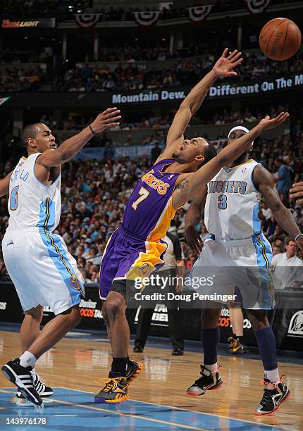 Ramon Sessions of the Los Angeles Lakers looses control of the ball against Arron Afflalo of the Denver Nuggets and Ty Lawson of the Denver Nuggets...