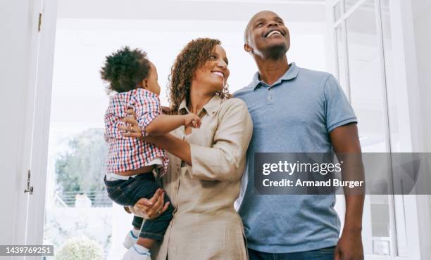 real estate, new home and black family with baby in door happy with house, property or entrance for mortgage loan success. happy family couple and child excited about moving into new house investment - family excitement stock pictures, royalty-free photos & images