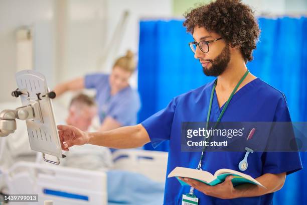 checking dosages on the ward - medical student stock pictures, royalty-free photos & images