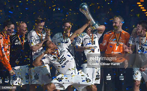 Daniel Narcisse of THW Kiel celebrates with the trophy after winning the Lufthansa Final 4 match between THW Kiel and SG Flensburg - Handewitt at the...