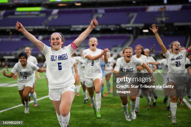 Academy of Holy Angels High School players, including Madden Smith , celebrate their shootout victory against Mahtomedi High School during the girls'...