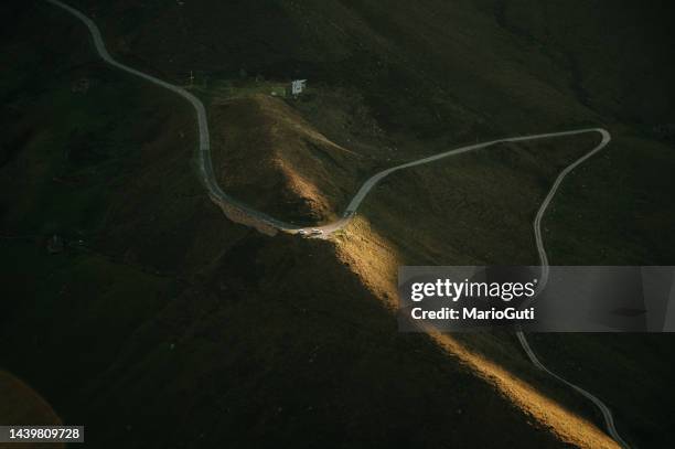 narrow mountain road from above - cantabria stock pictures, royalty-free photos & images