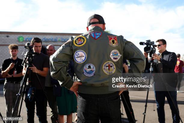 Sen. Mark Kelly speaks to the media at a canvasing location at Llantera Garcia’s Auto Service on November 07, 2022 in Tucson, Arizona. With one day...