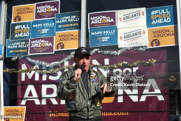 Sen. Mark Kelly speaks to volunteers at a canvasing location at Llantera Garcia’s Auto Service on November 07, 2022 in Tucson, Arizona. With one day...