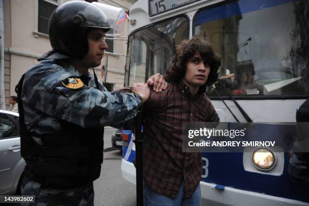 Riot police, officers escort an anti-Putin protester, who was detained at the Tverskoi Boulevard in central Moscow, on May 7, 2012. Moscow police...