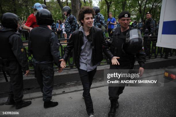 Riot police, officers escort an anti-Putin protester, who was detained at the Tverskoi Boulevard in central Moscow, on May 7, 2012. Moscow police...