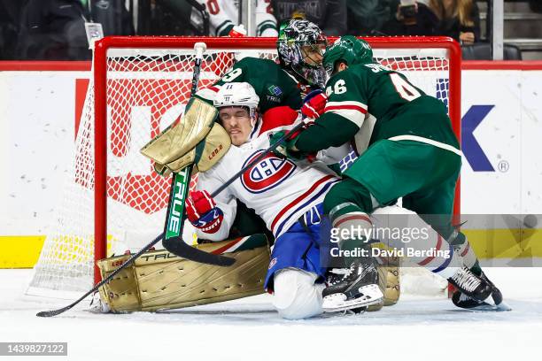 Jared Spurgeon of the Minnesota Wild checks Brendan Gallagher of the Montreal Canadiens while Marc-Andre Fleury of the Minnesota Wild defends his net...