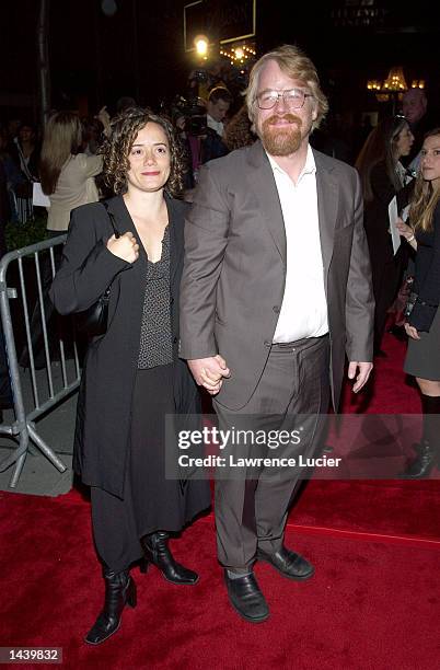 Actor Philip Seymour Hoffman and an unidentified guest attend the premiere of "Red Dragon" on September 30, 2002 in New York City.