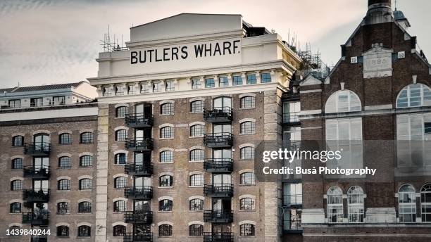 butler's wharf at shad thames on the south bank of the river thames, near london's tower bridge. london, england - shad stock pictures, royalty-free photos & images