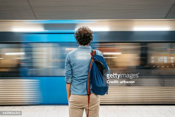 young man waiting for a subway train in stockholm - commuting to work stock pictures, royalty-free photos & images
