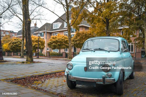 an old car in amsterdam, holland during autumn - car park stock-fotos und bilder