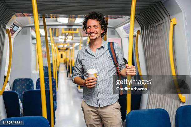 young man riding in a subway train in stockholm - stockholm metro stock pictures, royalty-free photos & images