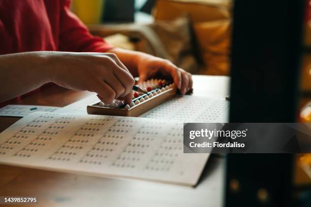 woman is playing board games at the table - accounting abacus stock pictures, royalty-free photos & images
