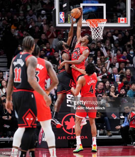 Christian Koloko of the Toronto Raptors blocks Patrick Williams of the Chicago Bulls during the first half of their basketball game at the Scotiabank...